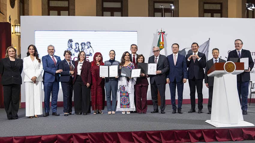 Sheinbaum, Ebrard and more than a dozen Mexican governors stand on stage at a press conference displaying signed letters of intent for the new economic development hubs