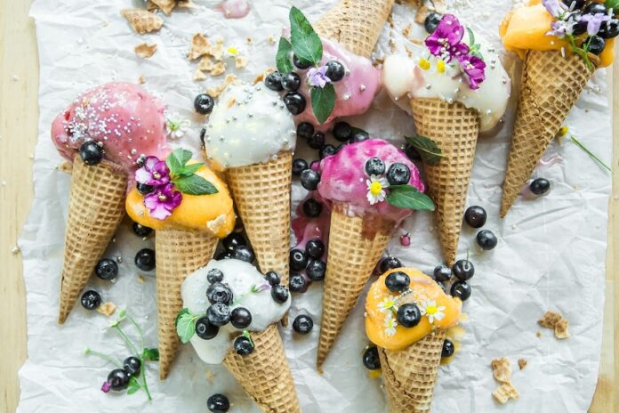 Several different flavors of ice cream in cones